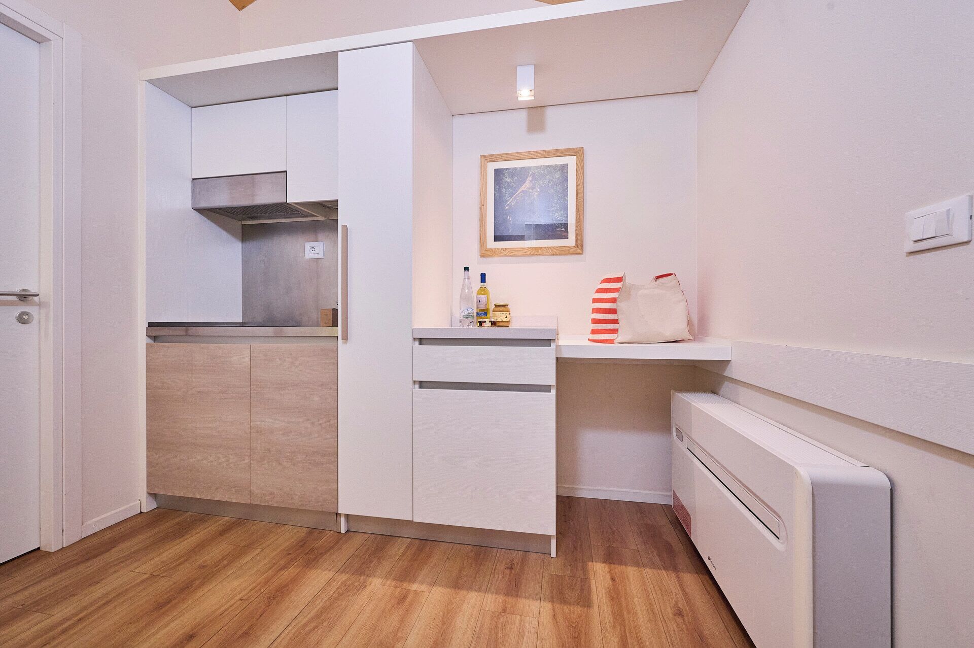 A compact kitchen with a built-in oven, a microwave, and a small countertop.