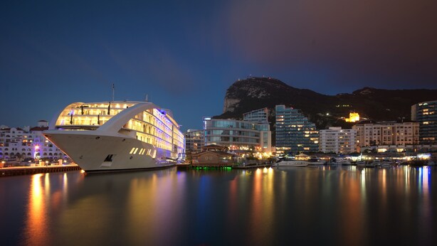 A waterfront hotel with a modern design, featuring a large white building with multiple balconies and a prominent dome structure. - Sunborn Gibraltar Yacht Hotel Resort (Gibraltar)