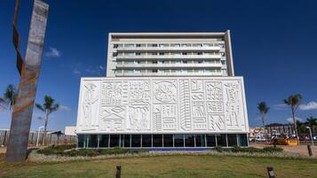 Un edificio moderno con una fachada distintiva que presenta diversos símbolos y patrones culturales.
