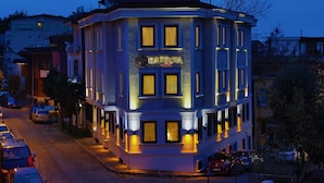 A hotel with a classic architectural style, featuring a prominent sign and multiple windows.