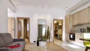 A modern living room with a grey sofa, wooden coffee table, and a small side table with a wine bottle and glass.