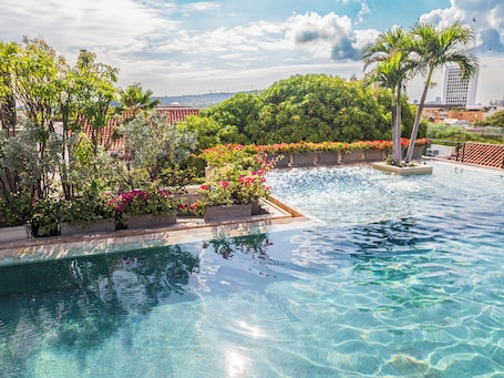 Outdoor pool, open 10:00 AM to 8:00 PM, pool umbrellas. Bastión Luxury Hotel