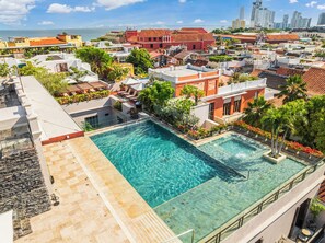 Outdoor pool, open 10:00 AM to 8:00 PM, pool umbrellas