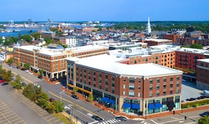 A multi-story hotel with a brick facade, large windows, and a flat roof.