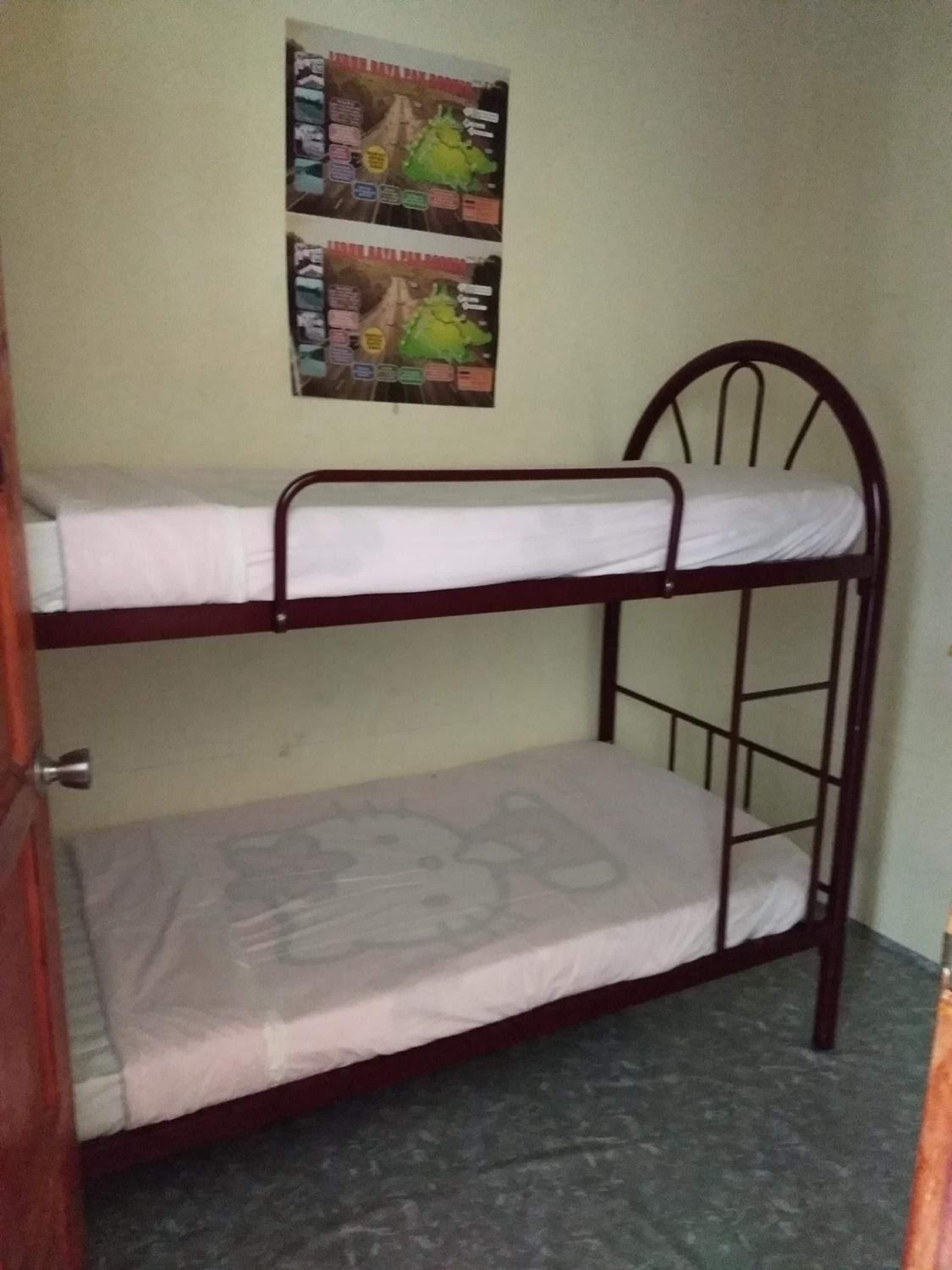 A bunk bed with a poster on the wall.