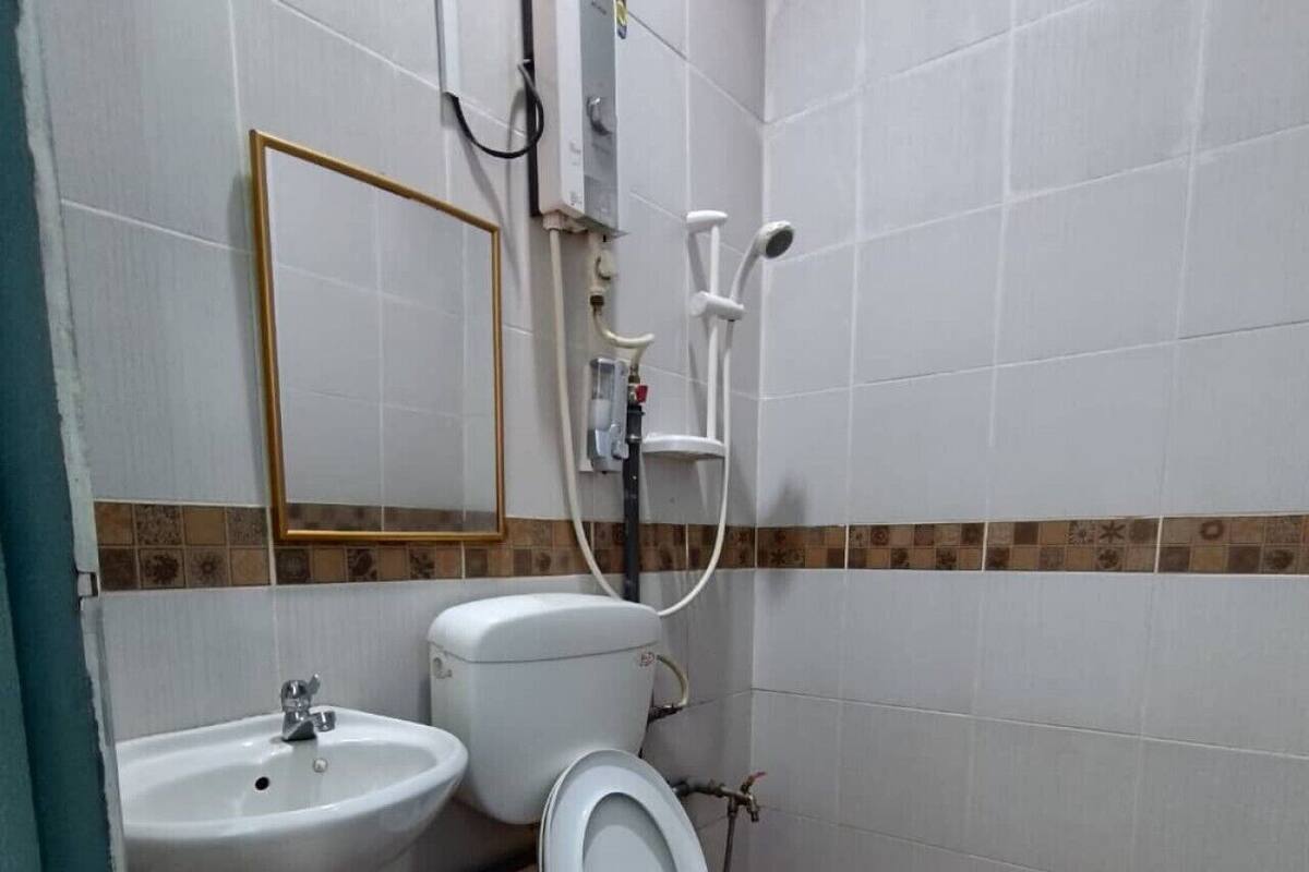 A bathroom with a sink, toilet, and shower.