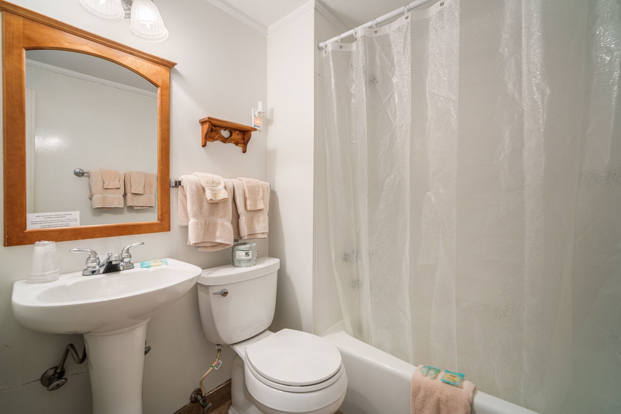 A bathroom with a sink, toilet, and bathtub.