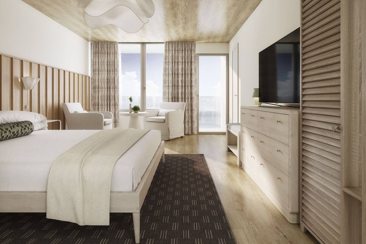 Quarto de hotel moderno com uma cama grande, televisão, escrivaninha e vista para a cidade.
