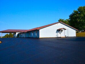 Simple, functional building with a covered parking area.