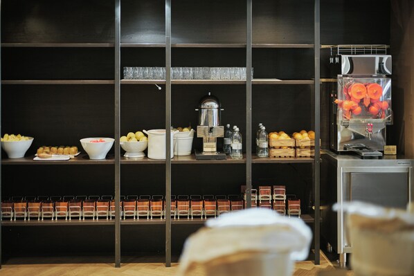 A buffet setup with various food items and a coffee machine. - Hotel Europa (Valtournenche)