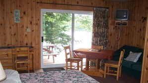 A room with a bed, a desk, a table, and a couch. - H & H Restaurant and Resort (The Archipelago)
