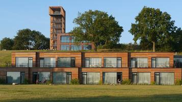 A modern multi-story building with large windows and a tower structure.