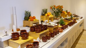 A buffet setup with various food items and serving utensils. - Nausicaa Luxury Villas By Louis Hotels (Paralimni)