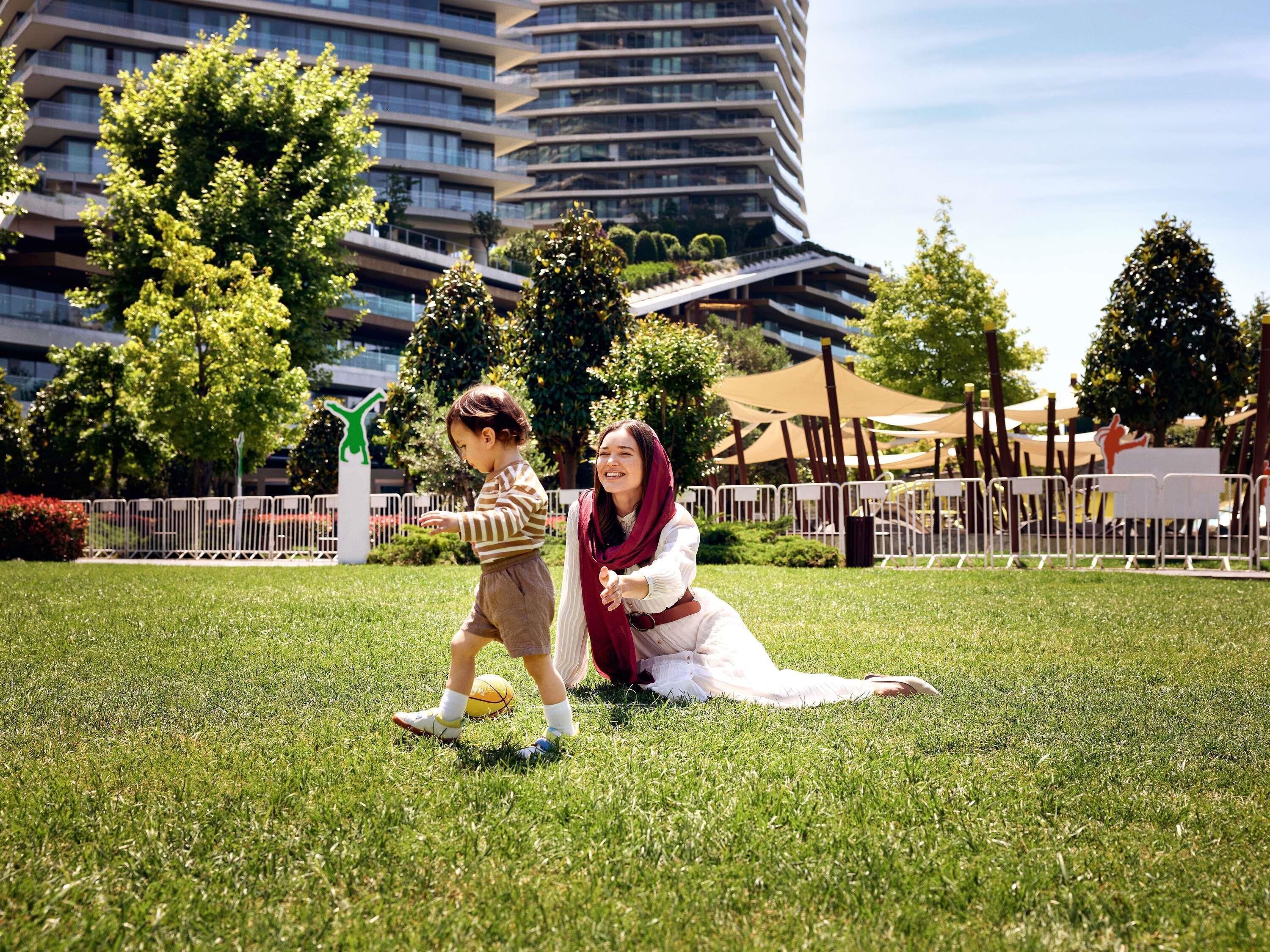 A grassy area with a modern building in the background.