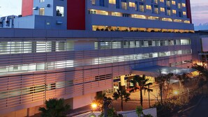 A modern hotel with multiple floors, large windows, and a prominent sign at the top. - Swiss-Belinn Malang (Malang)