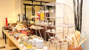 A buffet setup with various food items and beverages. - Swiss-Belinn Malang (Malang)