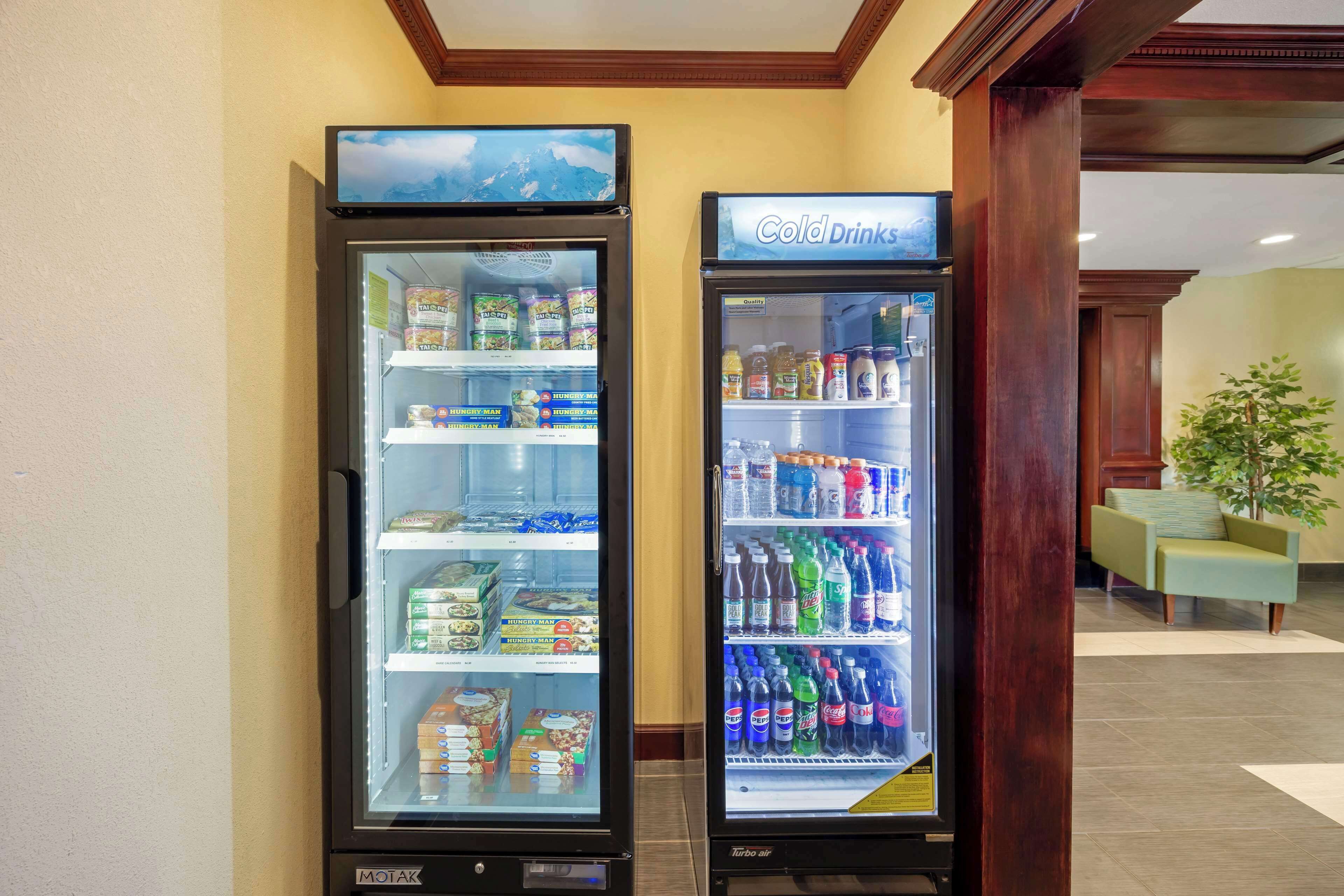 Two refrigerated beverage dispensers, one labeled "Cold Drinks" and the other "Turbo Air," stocked with various beverages and snacks.