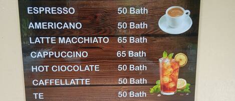 Un panel con el menú que muestra diferentes opciones de café y té, precios y descripciones de las bebidas.
