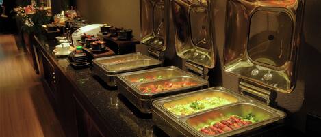 A buffet with various food items in metal containers.