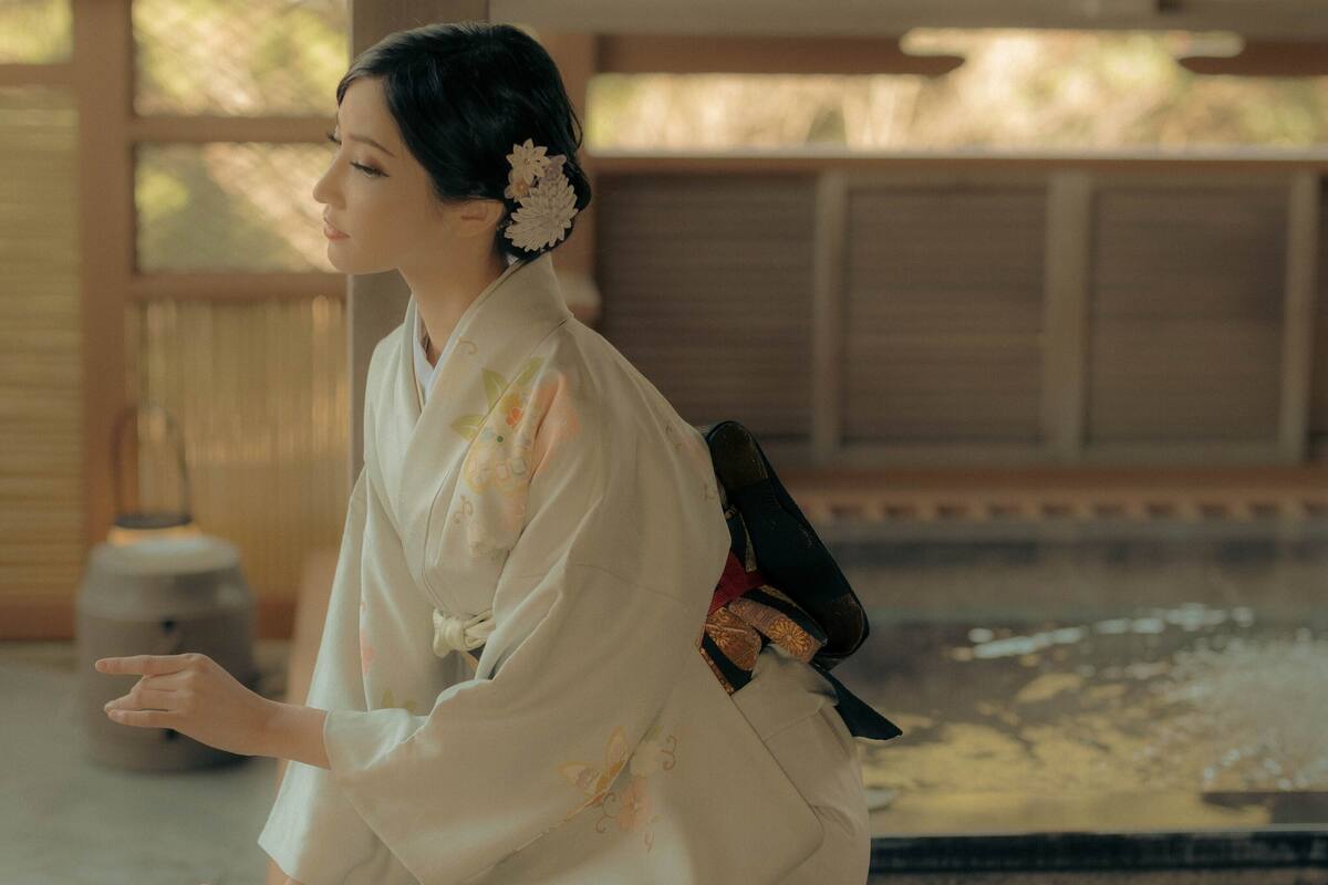 A traditional Japanese room with tatami flooring, a low wooden table, and a sliding door.
