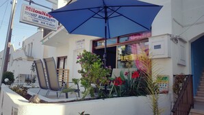 Um edifício de apartamentos turísticos com área de estar externa e um balcão de recepção.