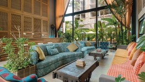 A spacious indoor area with a large sectional sofa, a coffee table, and a patterned couch. - Sugar Marina Resort -Surf- Kata Beach (Karon)