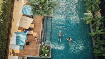 Una piscina al aire libre, sillones reclinables de piscina