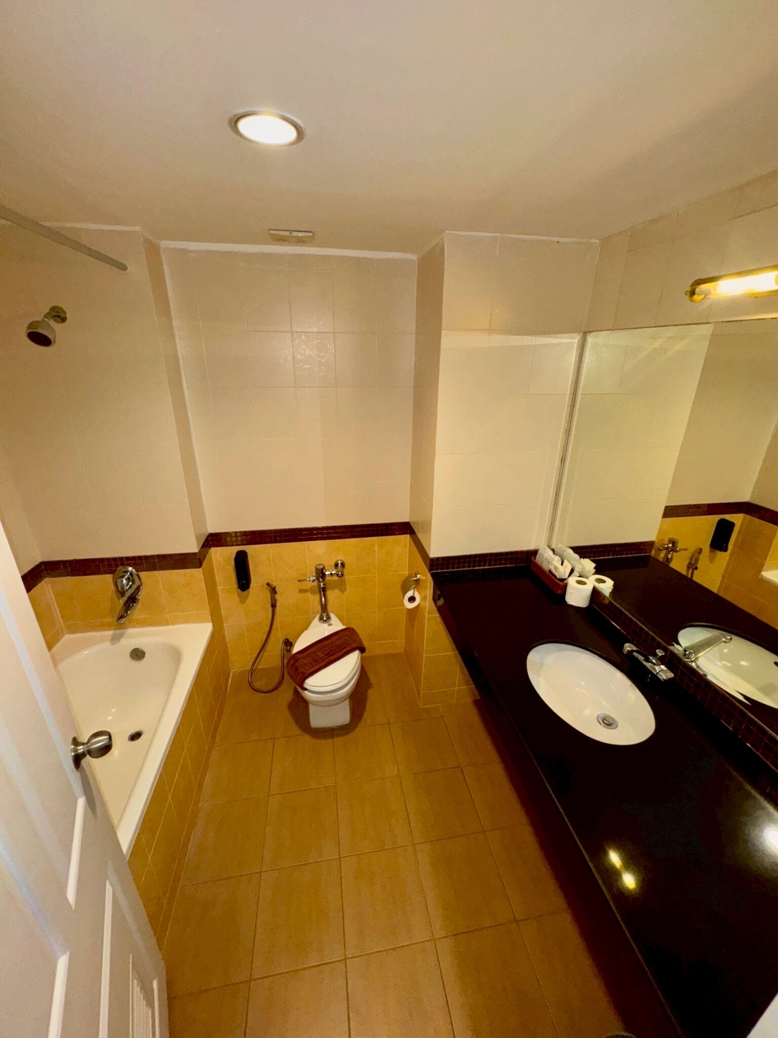 A bathroom with a bathtub, two sinks, and a toilet.
