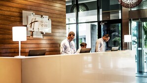A reception desk with a wooden panel wall and a sign reading "Holiday Inn Express". - Holiday Inn Express Port Moresby by IHG (Port Moresby)