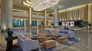 A spacious lobby with high ceilings, a grand chandelier, and multiple seating areas. - Shangri-La Tianjin (Tianjin)