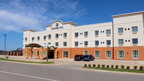 A hotel with a flat roof, a central entrance, and a parking lot. - Cotulla Express Inn (Cotulla)