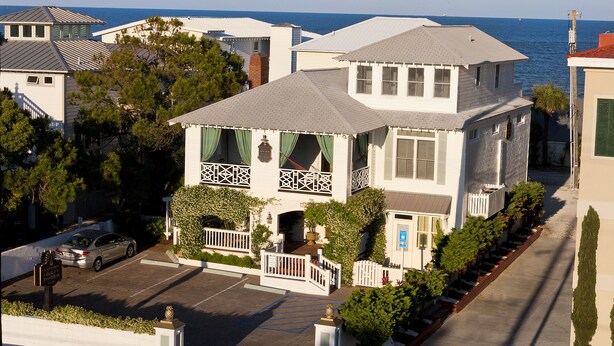 A two-story house with a balcony, a garage, and a driveway. - Desoto Beach Bed & Breakfast (Tybee Island)