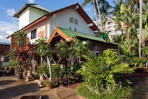 Set amidst lush tropical vegetation, this two-story building offers a tranquil retreat.