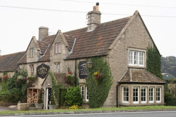 A traditional stone building with a sign that reads "Crown Inn." - Crown Inn (Chippenham)