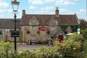 A traditional stone building with a sign reading 'The Crown Inn Pub & Rooms'. - Crown Inn (Chippenham)