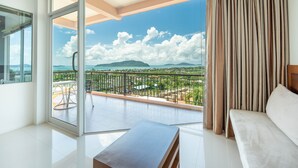 Un salon moderne avec un balcon, un canapé et une table.