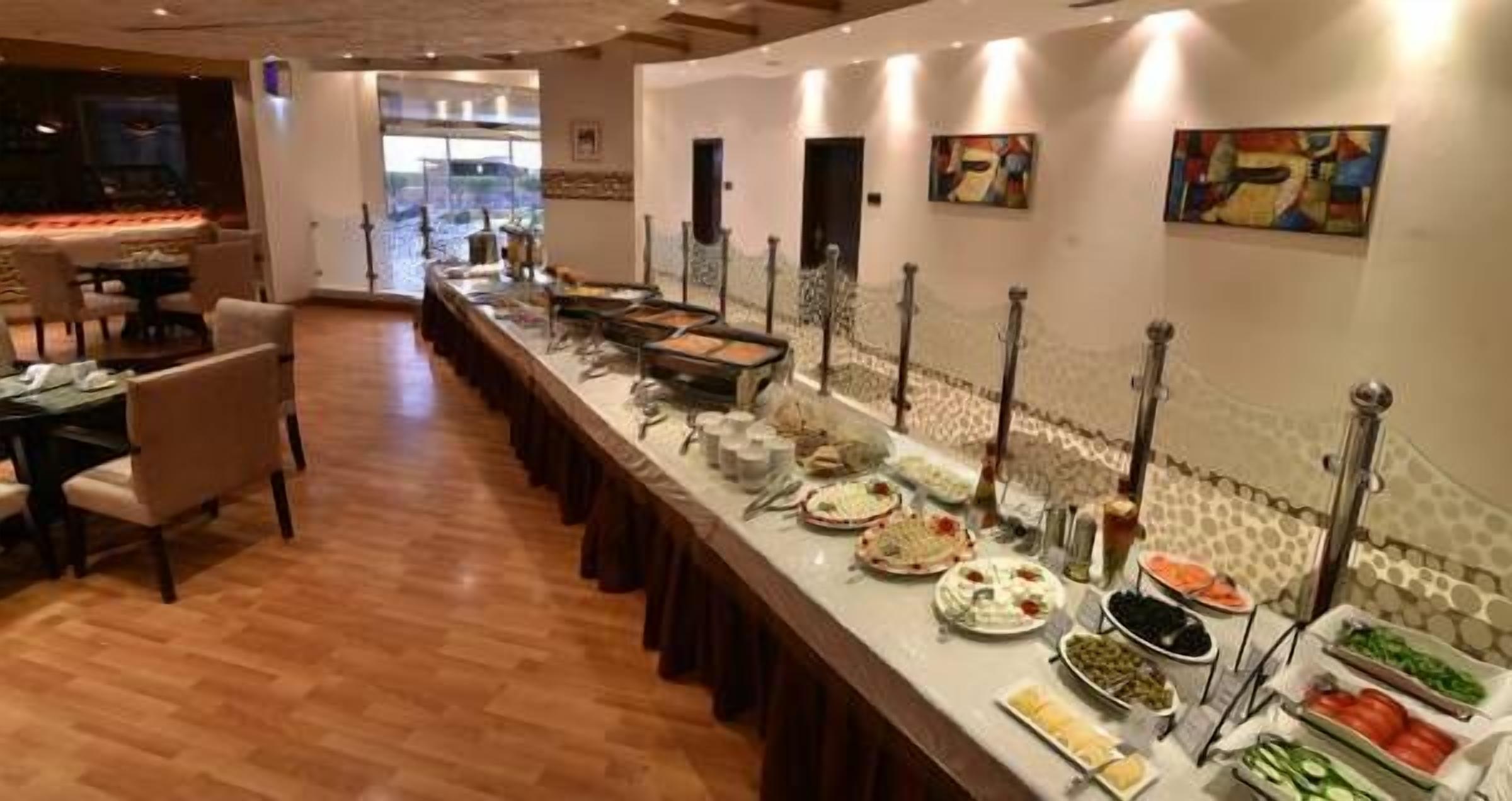 A buffet setup with various food items and a long counter.