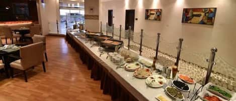 A buffet setup with various food items and a long counter.