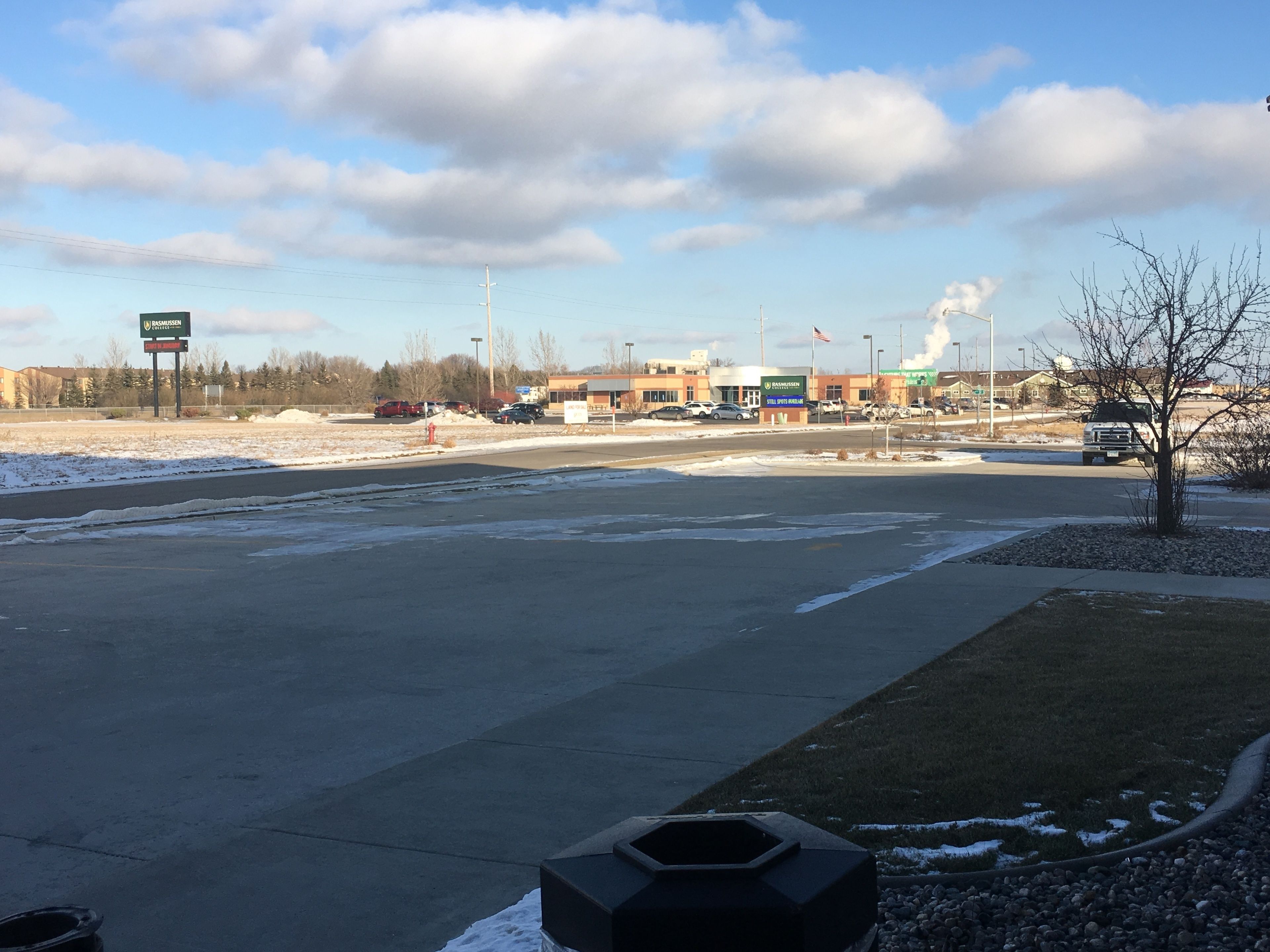 A parking lot with a building in the background.