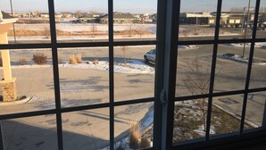 A parking lot with a building in the background. - Microtel Inn & Suites By Wyndham Moorhead Fargo Area (Moorhead)