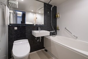 Un baño moderno con inodoro, lavamanos y bañera.