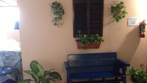 A blue bench, potted plants, a fire extinguisher, and a sign reading "SAVE OUR PLANET". - Dream's Hotel Puerto Rico (San Juan)