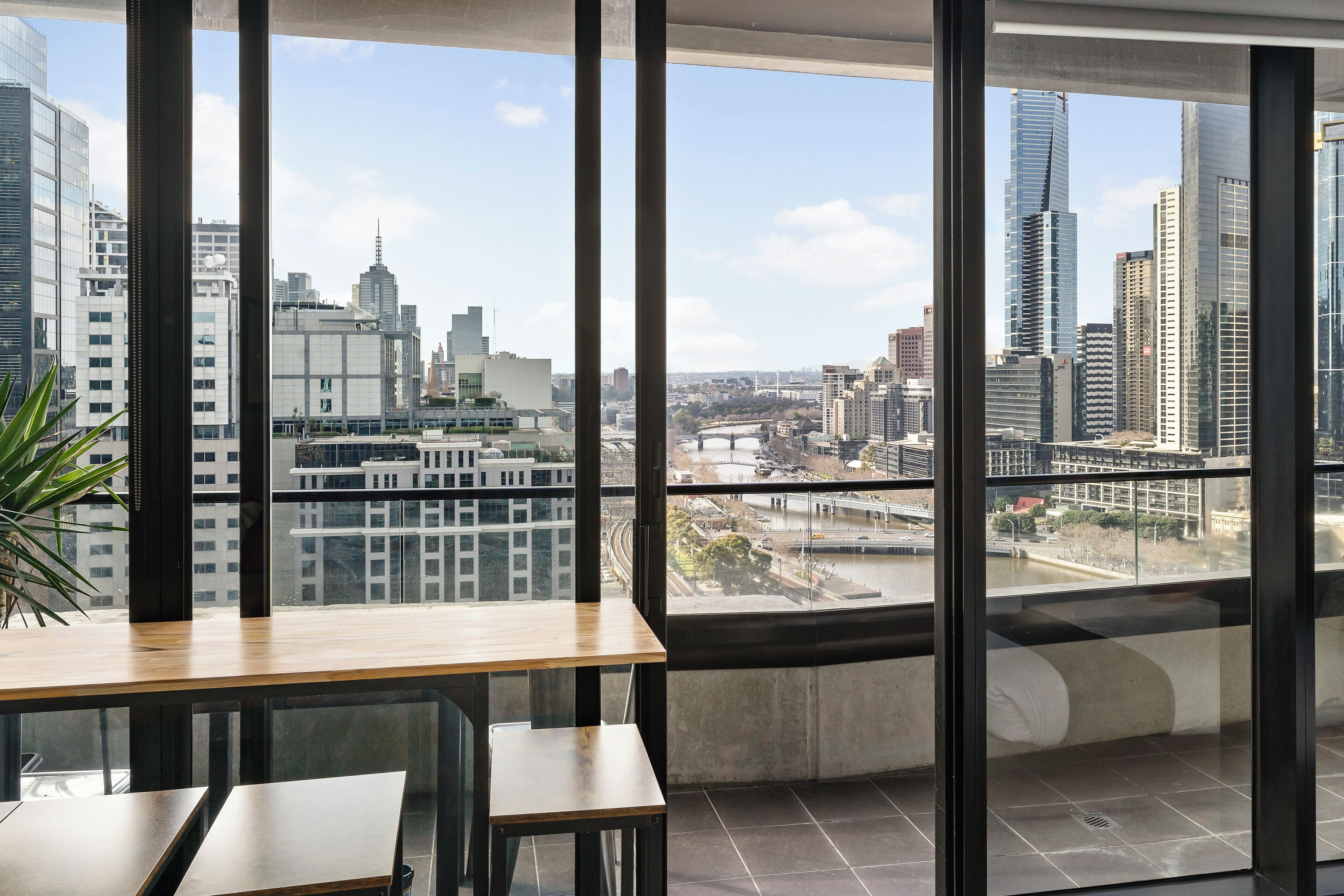 A modern office space with large windows offering a city view.