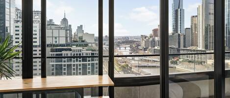 A modern office space with large windows offering a city view.