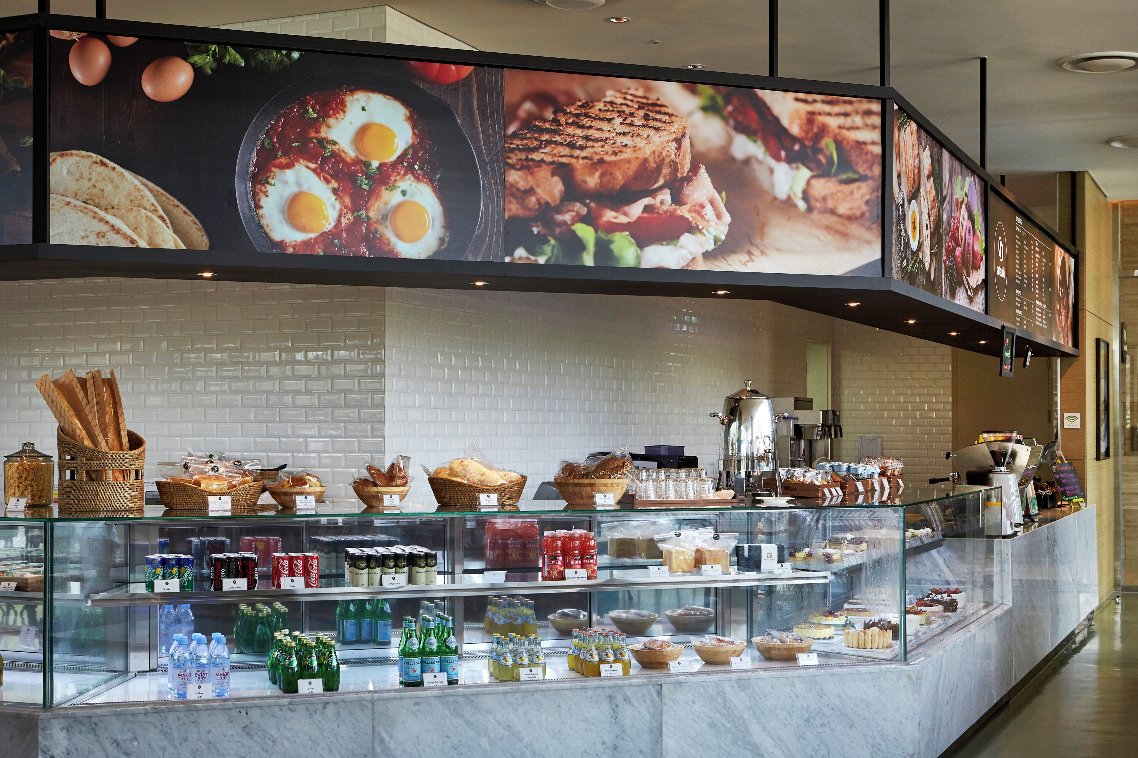 A food display area with various baked goods and beverages.