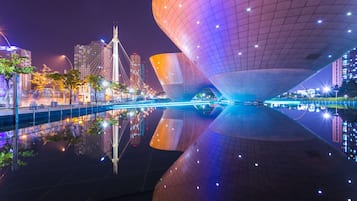 A modern architectural structure with a large, reflective surface and a grid-like pattern.