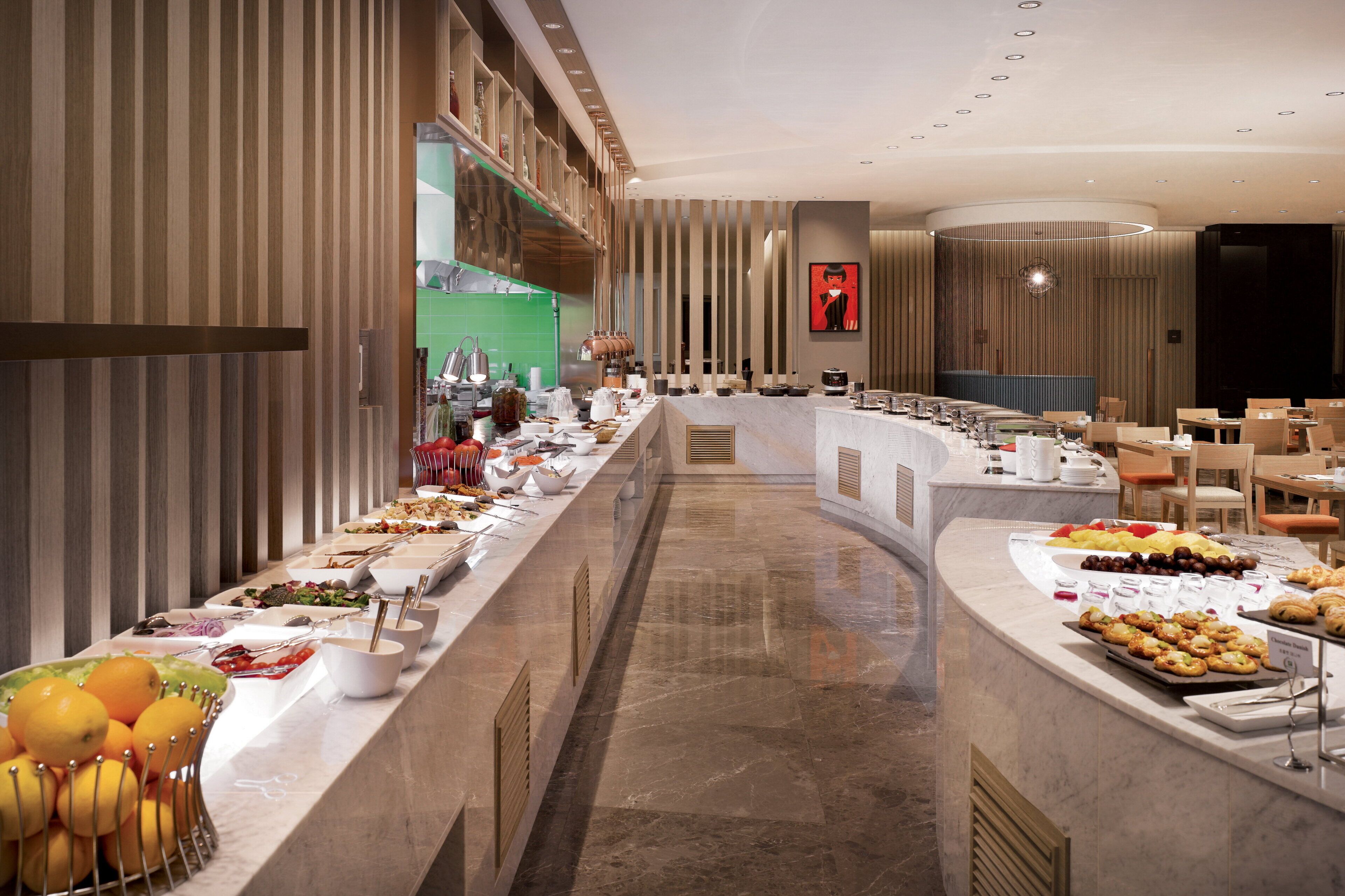 A buffet setup with various food items and a long serving counter.