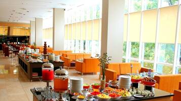 A buffet area with various food items and a coffee station.