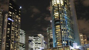 A nighttime cityscape with illuminated high-rise buildings. - Inner Melbourne Serviced Apartments (Southbank)