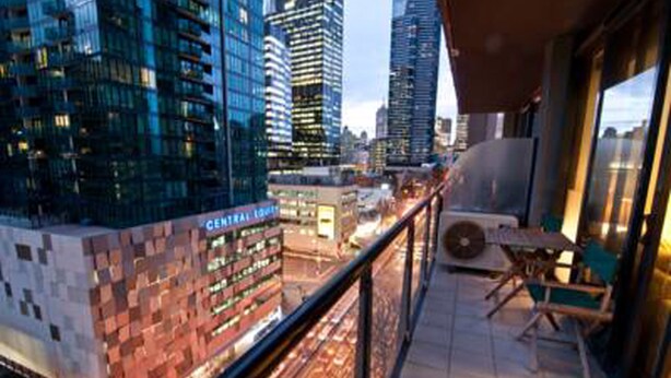 A cityscape view from a balcony with a view of Central Park and tall buildings. - Inner Melbourne Serviced Apartments (Southbank)